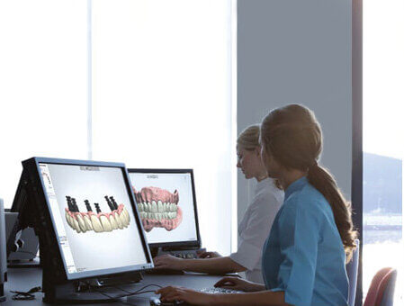 Morgan Street Dental Centre Dental Implants Image - Dentists Working on Computer with Dental Implants 