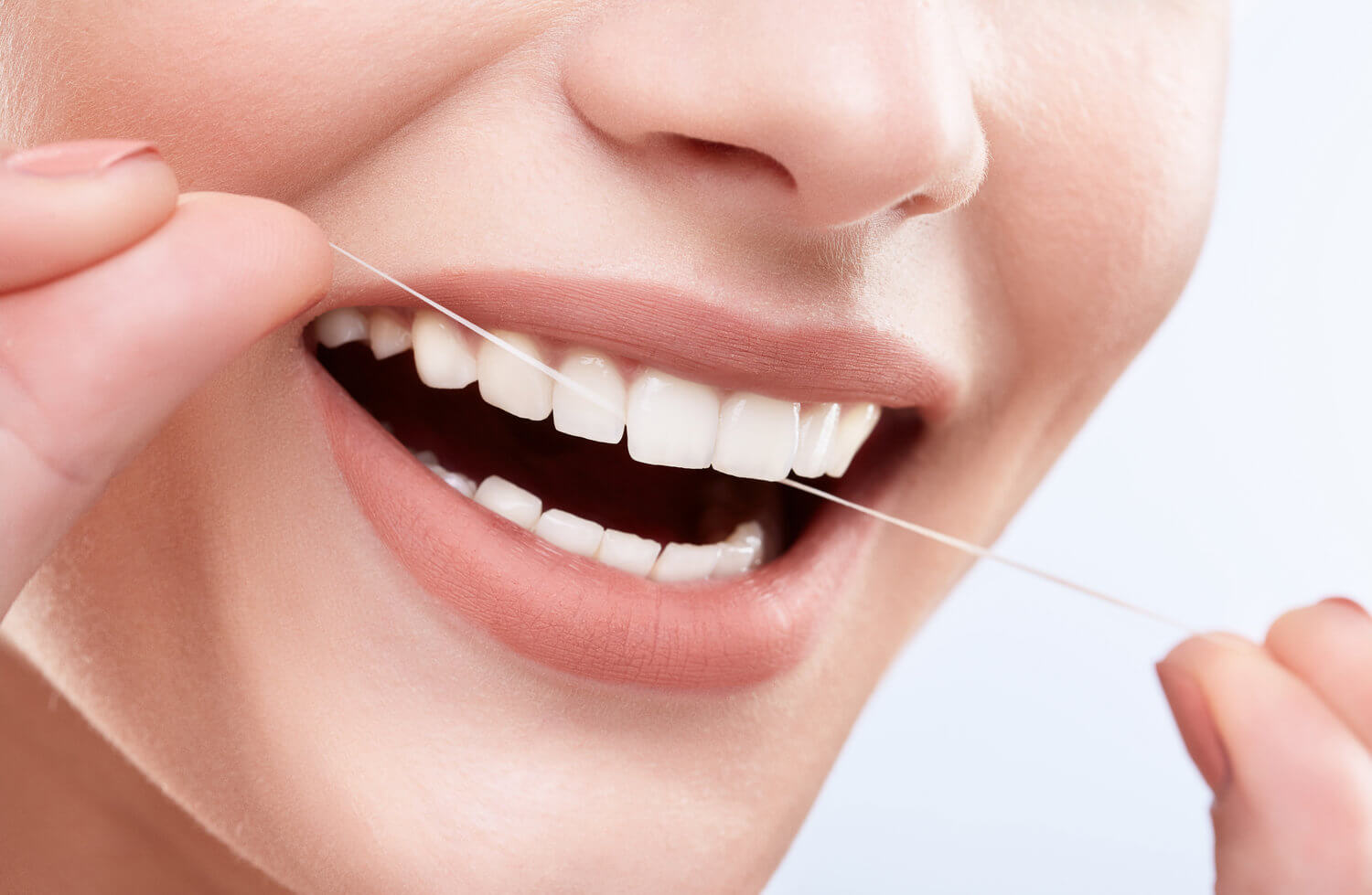 Morgan Street Dental Centre Preventive Care and Dental Hygiene - Woman with White Teeth Flossing