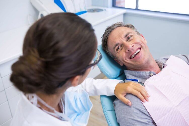 Morgan Street Dental Centre Worn Down Dentition - Elderly Man Smiling in a Dental Chair Happy 